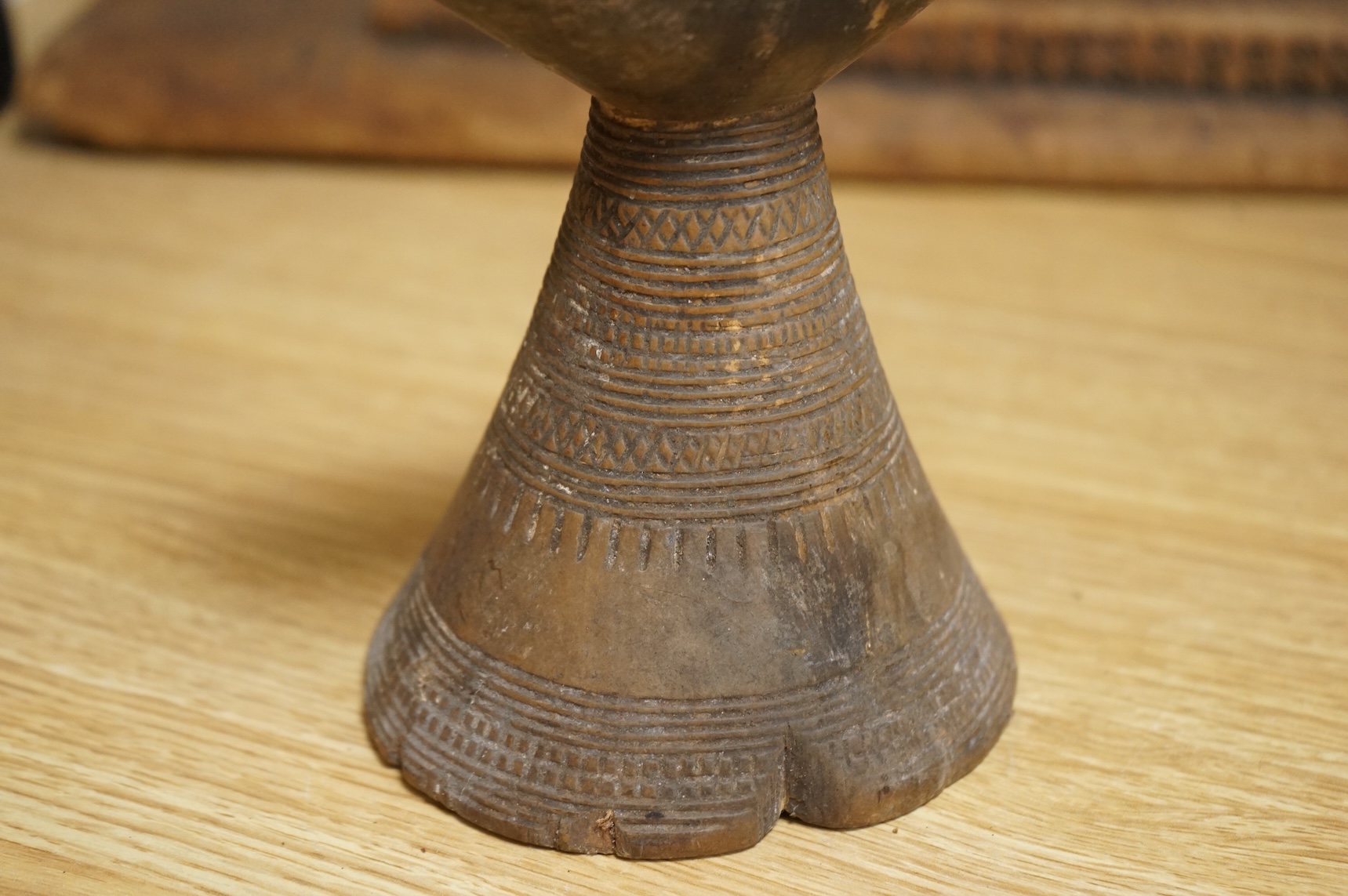 An Ashanti carved wood stool together with a similar headrest, tallest 41cm